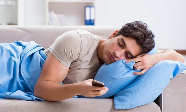 Man addicted to his mobile phone in bed — Stock Photo, Image