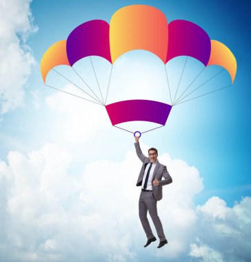Genç işadamı iş konseptinde paraşütle atlıyor