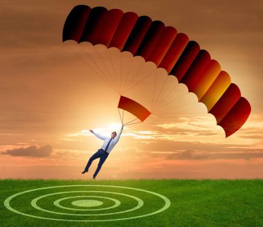 Genç işadamı iş konseptinde paraşütle atlıyor
