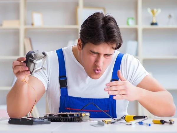 Computer repairman repairing desktop computer