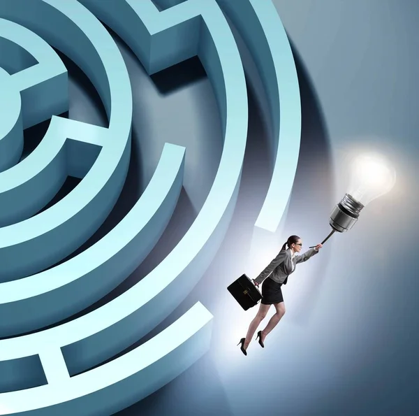 Businesswoman escaping from maze on balloon — Stock Photo, Image