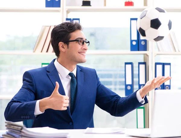 Businessman playing football in the office — Stock Photo, Image