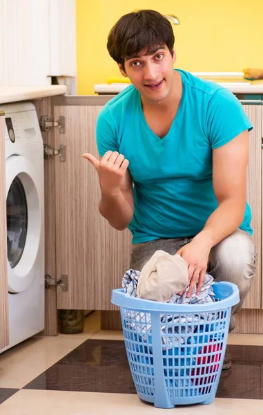 Młody mąż robi pranie w domu — Zdjęcie stockowe