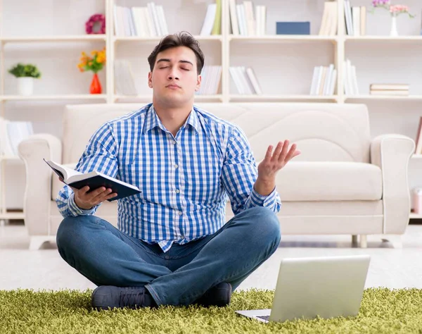 Young handsome man sitting on floor at home — Stock Photo, Image