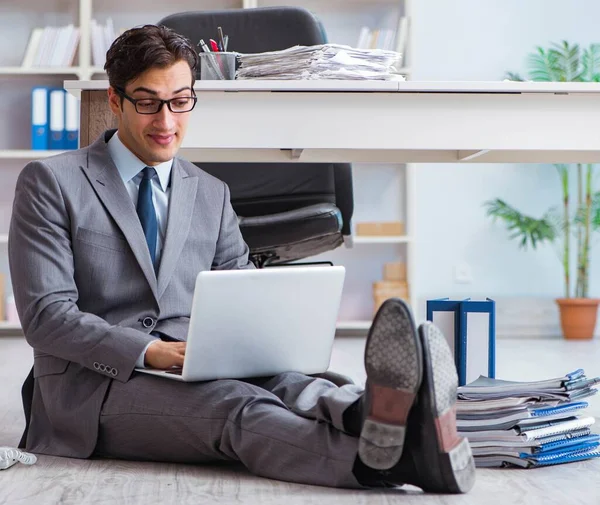 Empresário trabalhando e sentado no chão no escritório — Fotografia de Stock