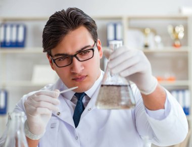 Genç araştırmacı bilim adamı bir su testi kirliliği araştırması yapıyor.