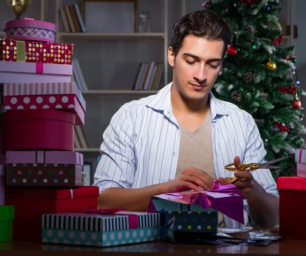 Man with many christmas gifts in boxes — Stock Photo, Image