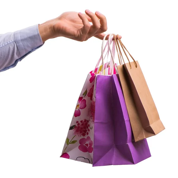 Mano sosteniendo bolsas de compras con compras de Navidad en la espalda blanca — Foto de Stock