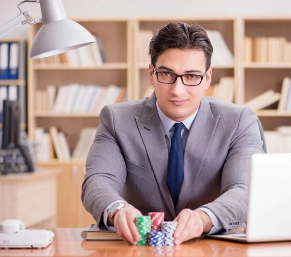 Businessman gambling playing cards at work — Stock Photo, Image