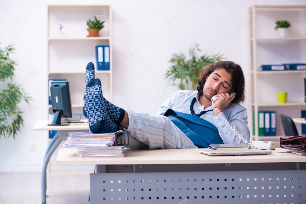 Male employee coming to work straight from bed