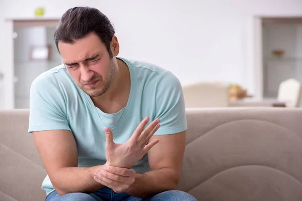 Injured young man suffering at home — Stock Photo, Image