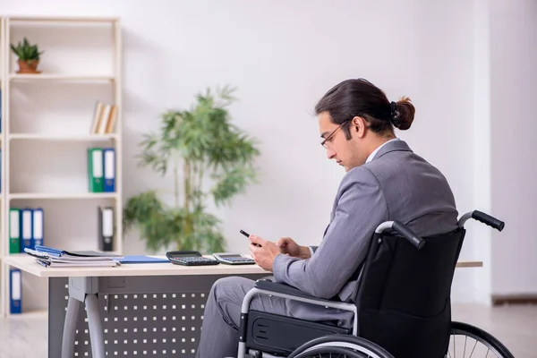 Young male employee in wheel-chair — Stock Photo, Image