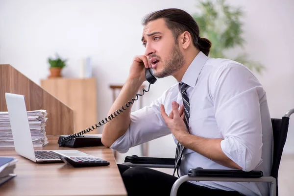 Young disabled employee suffering at workplace