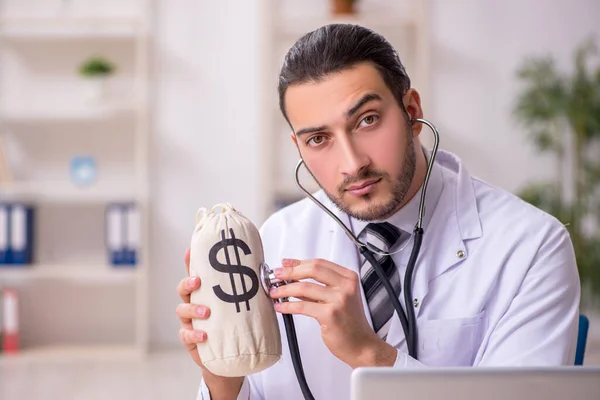 Young male doctor working in the clinic — Stock Photo, Image