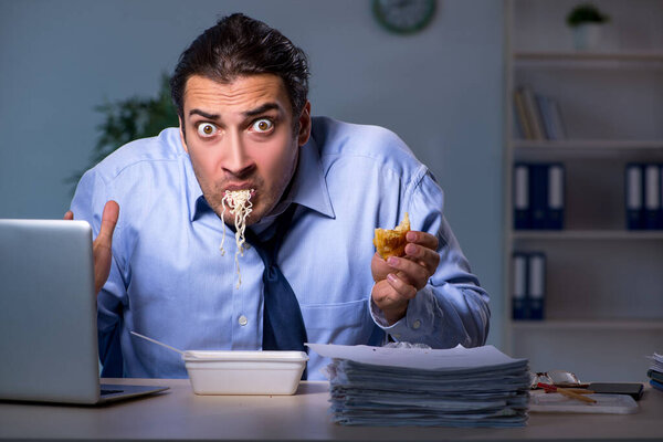 Hungry employee working late in the office