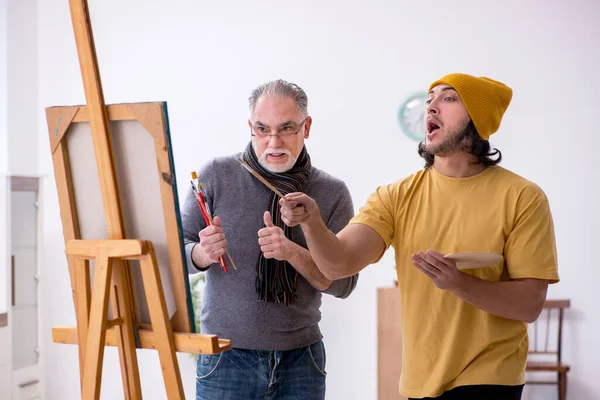 Starý muž bere lekce od mladého malíře — Stock fotografie