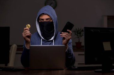 Erkek bilgisayar korsanı, güvenlik duvarını geç saatlerde hackliyor.