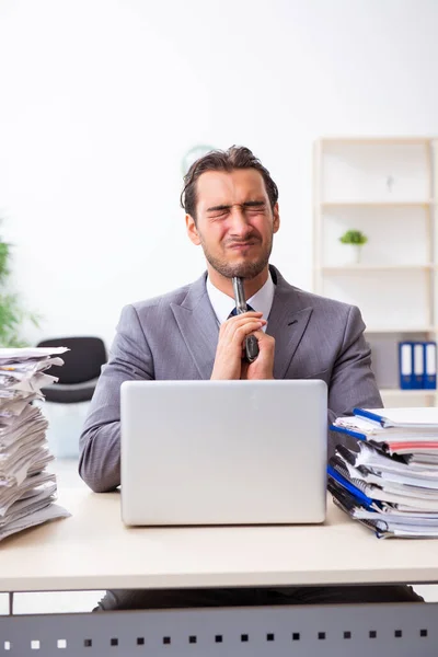 Junge männliche Mitarbeiter unzufrieden mit exzessiver Arbeit — Stockfoto