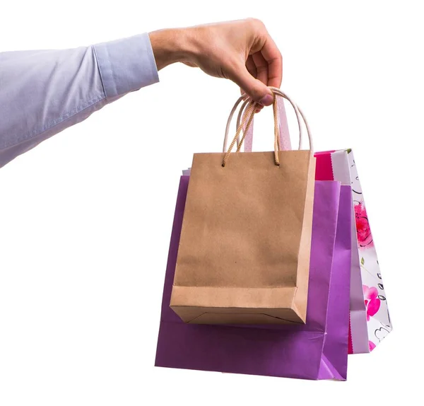 Hand holding shopping bags with christmas shopping on white back — Stock Photo, Image