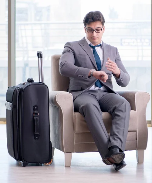 Young businessman in airport business lounge waiting for flight