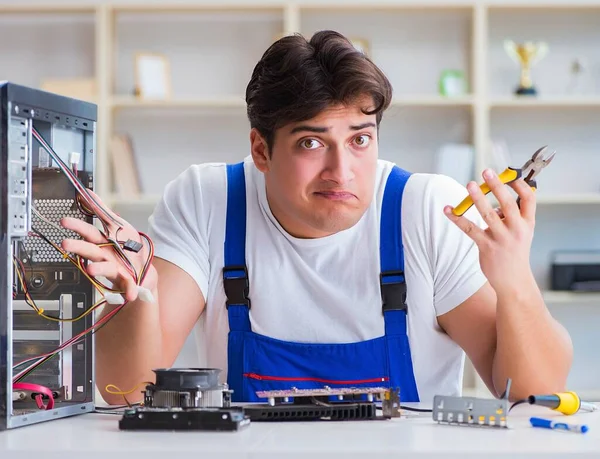 Computer repairman repairing desktop computer