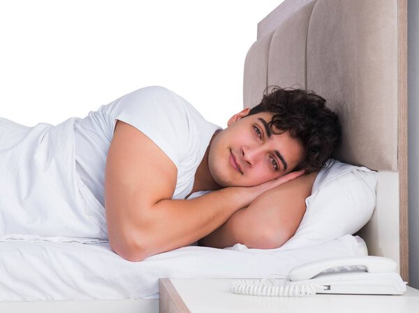 Man in bed suffering from insomnia