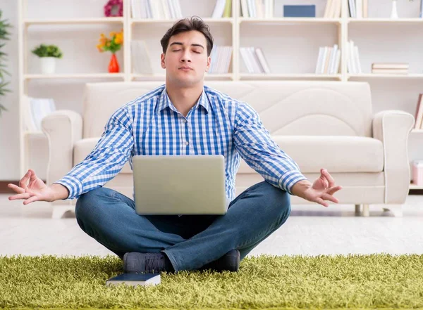 Young handsome man sitting on floor at home — Stock Photo, Image