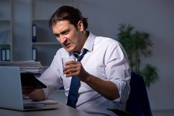 Alcohol verslaafde zakenman die laat op kantoor werkt — Stockfoto