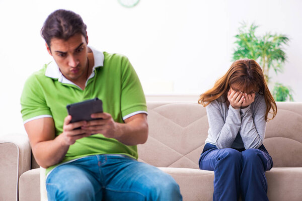 Young couple in gadget dependency concept