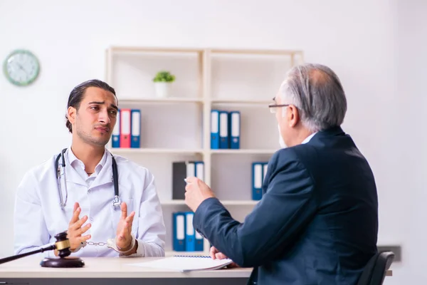 Male doctor in courthouse meeting with lawyer