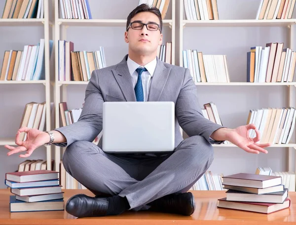 Businessman student in lotus position meditating with a laptop i — Stock Photo, Image