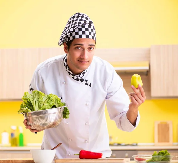 Joven cocinero profesional preparando ensalada en casa — Foto de Stock