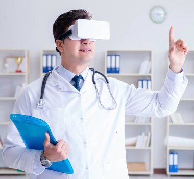 Sanal gerçeklik kulaklığı olan genç doktor ofiste çalışıyor.