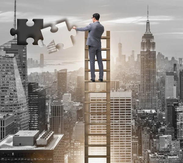 Businessman putting together jigsaw puzzle pieces — Stock Photo, Image