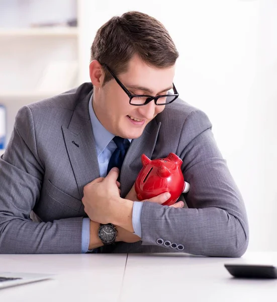 Young employee with piggybank in pension savings concept — Stock Photo, Image