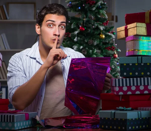 Man with many christmas gifts in boxes — Stock Photo, Image