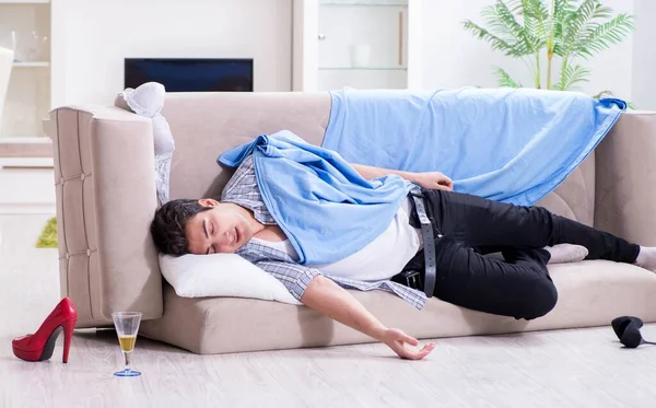 Man with mess at home after house party