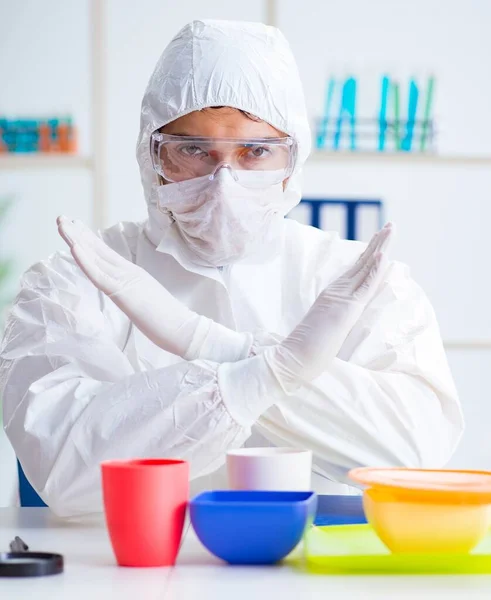 Chemist checking and testing plastic dishes