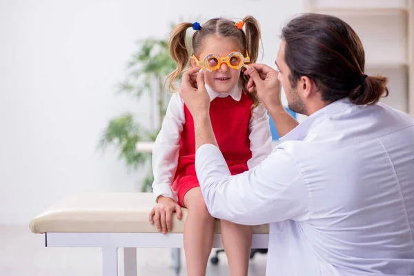 Gadis kecil mengunjungi dokter mata laki-laki muda — Stok Foto