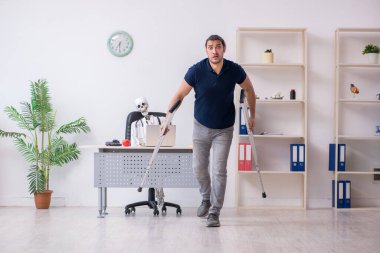 Genç bacağı yaralı bir adam ölü doktoru ziyaret ediyor.