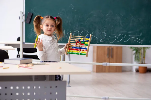 Klein meisje voor schoolbord in de klas — Stockfoto