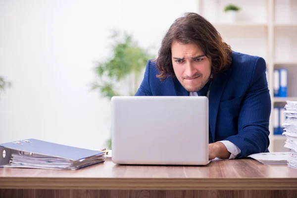 Junge männliche Mitarbeiter unzufrieden mit exzessiver Arbeit — Stockfoto