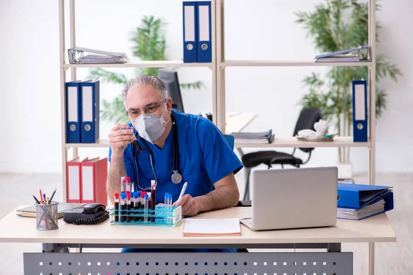 Vieux médecin masculin travaillant à la clinique — Photo