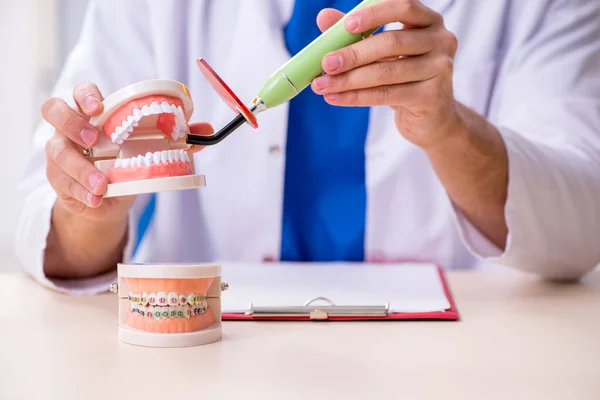 Young male dentist working in the clinic — Stock Photo, Image