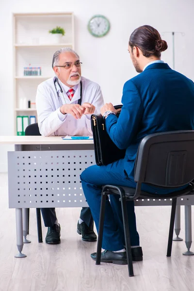 Male doctor and businessman discussing medical project — Stock Photo, Image