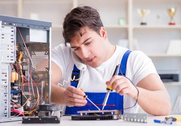 Computer repairman repairing desktop computer