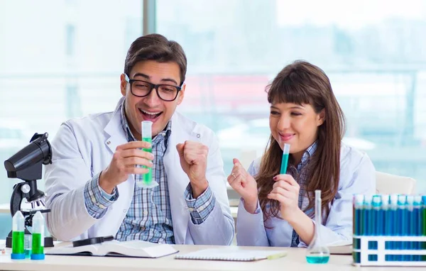 Due chimici che lavorano in laboratorio sperimentando — Foto Stock