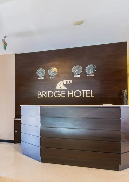 Hotel reception with desk and clocks — Stock Photo, Image