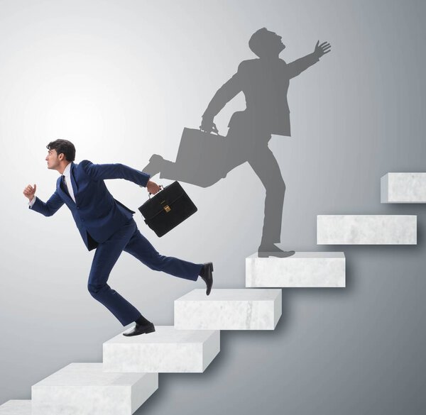 Businessman and his shadow in business concept