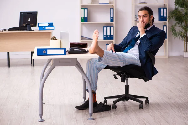 Young male employee during pandemic at workplace — Stock Photo, Image